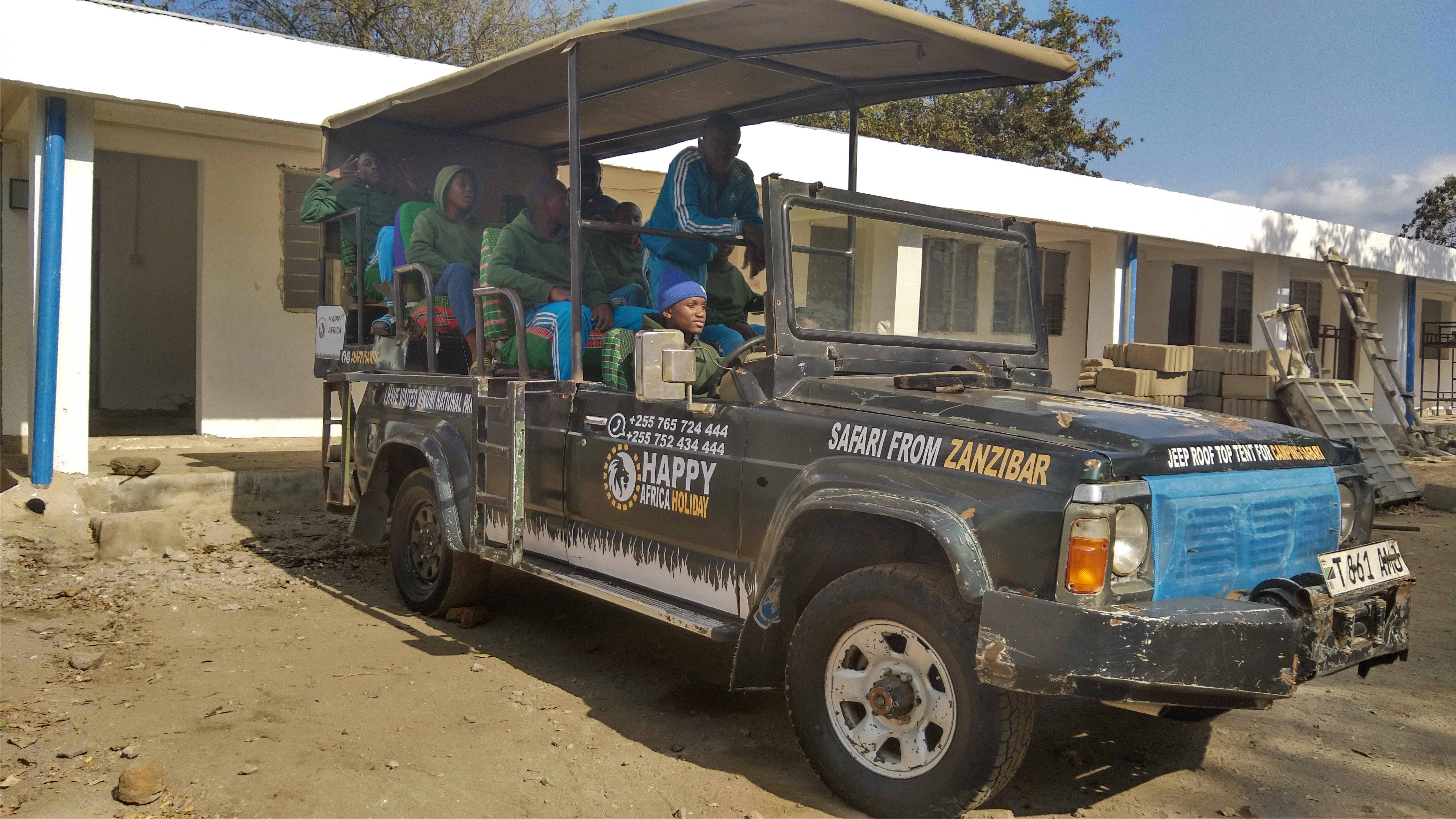 Boys having photoshoot in safari vehicle